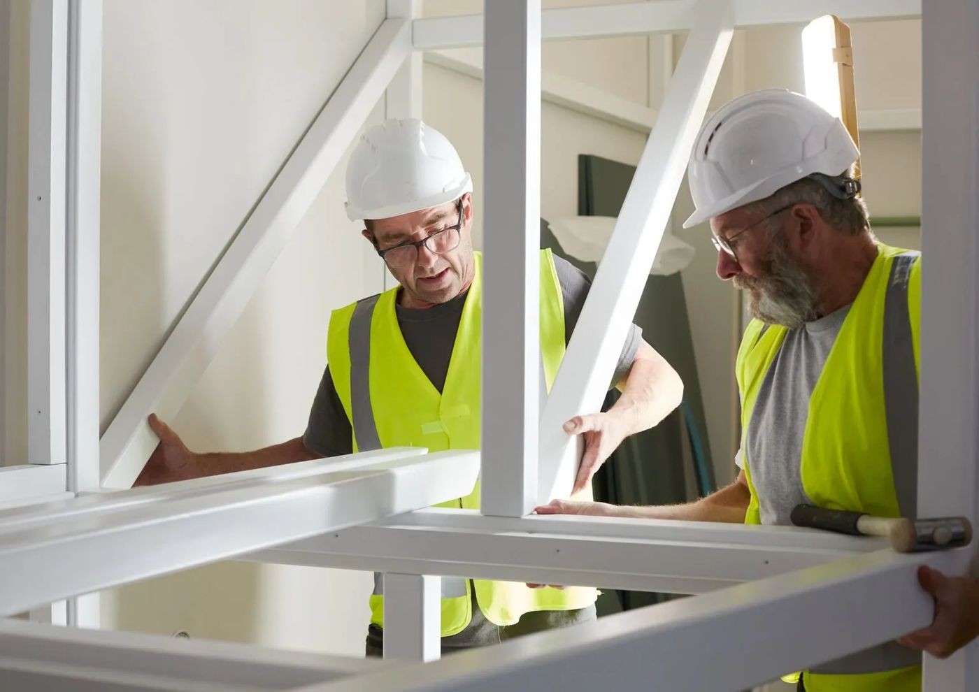 Assembling a galvanized steel play structure frame at a project site