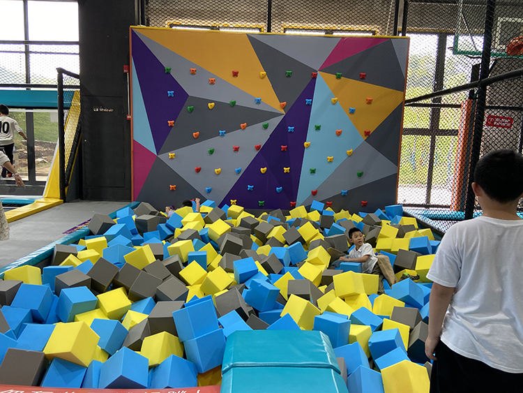 Foam pit with climbing wall at a trampoline park