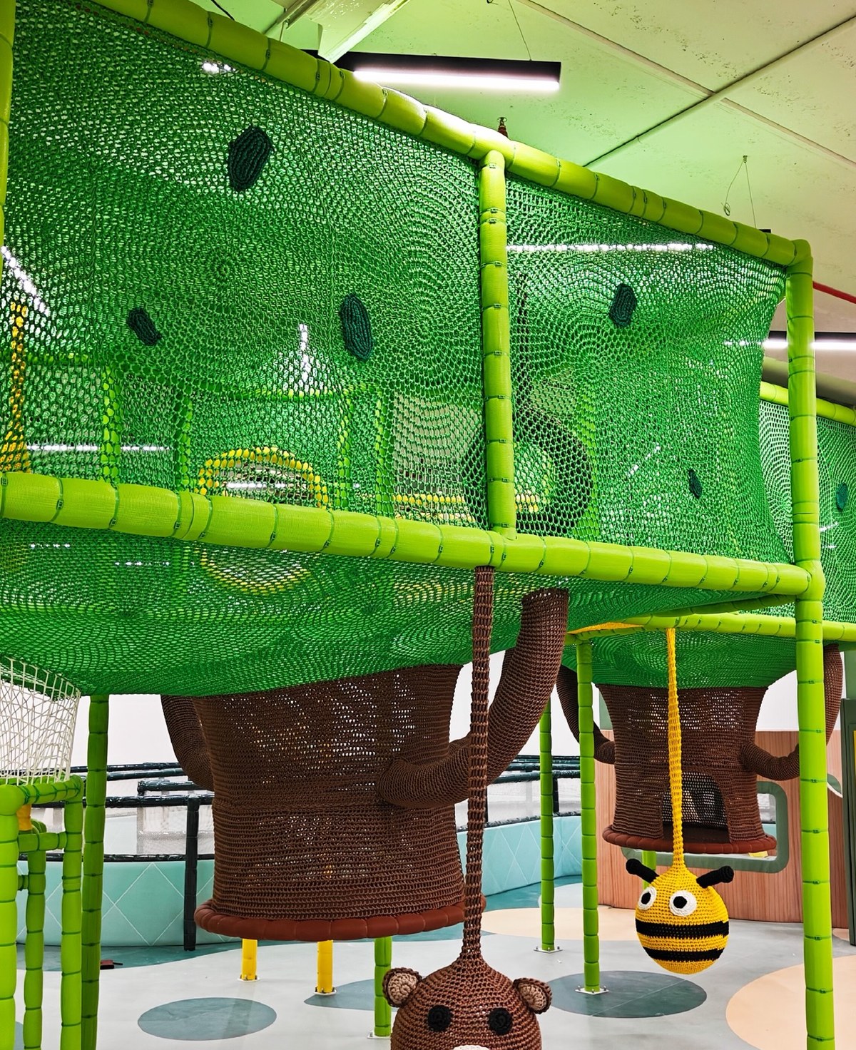 Indoor crochet tree canopy with hanging bear and bee swings