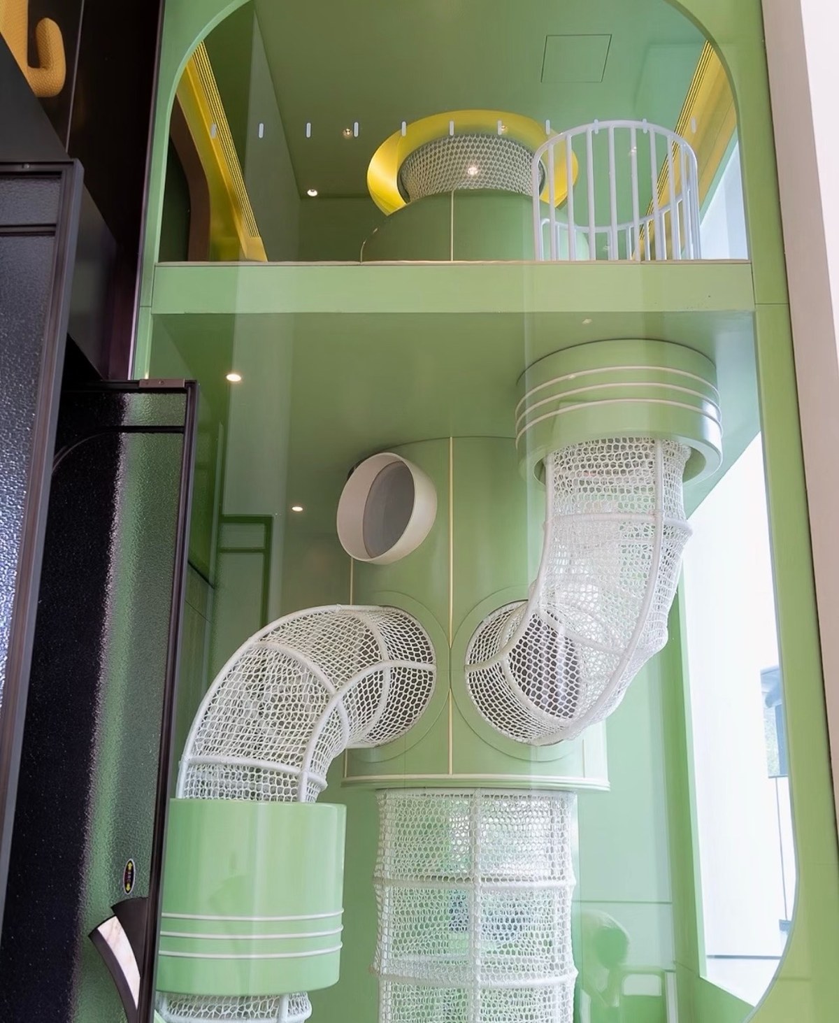 Stacked white net tubes inside a mint-green tower