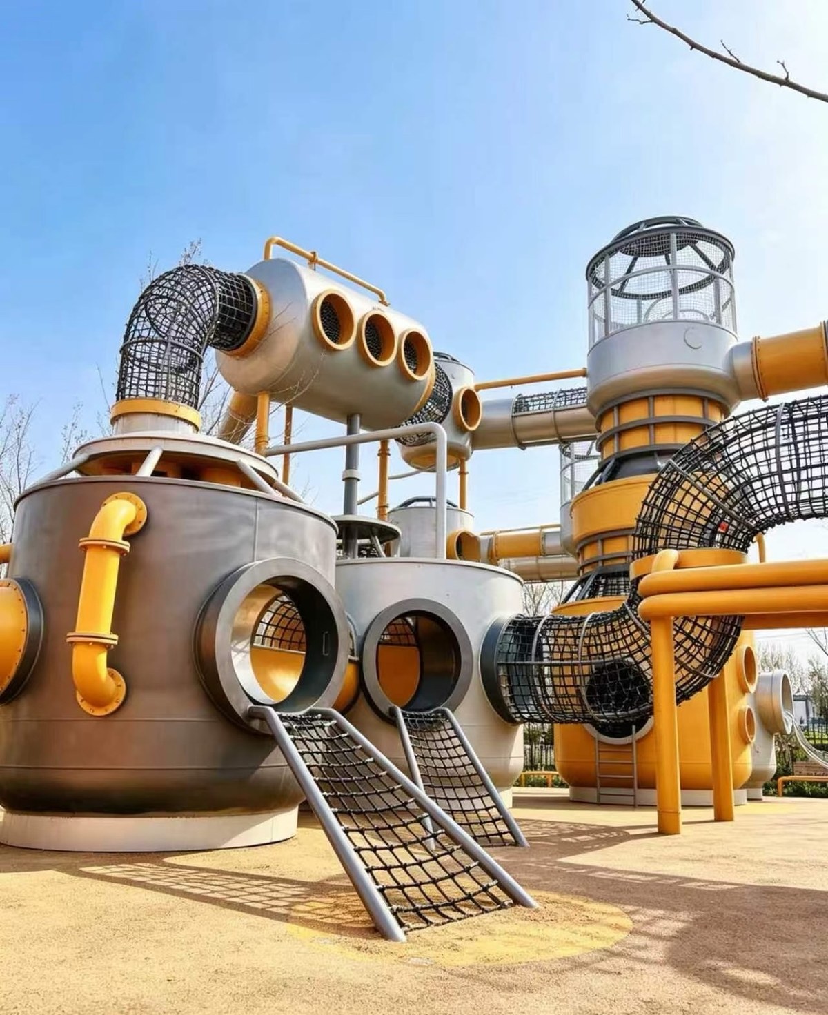 Steel tank playground with crawl tubes and net ramps