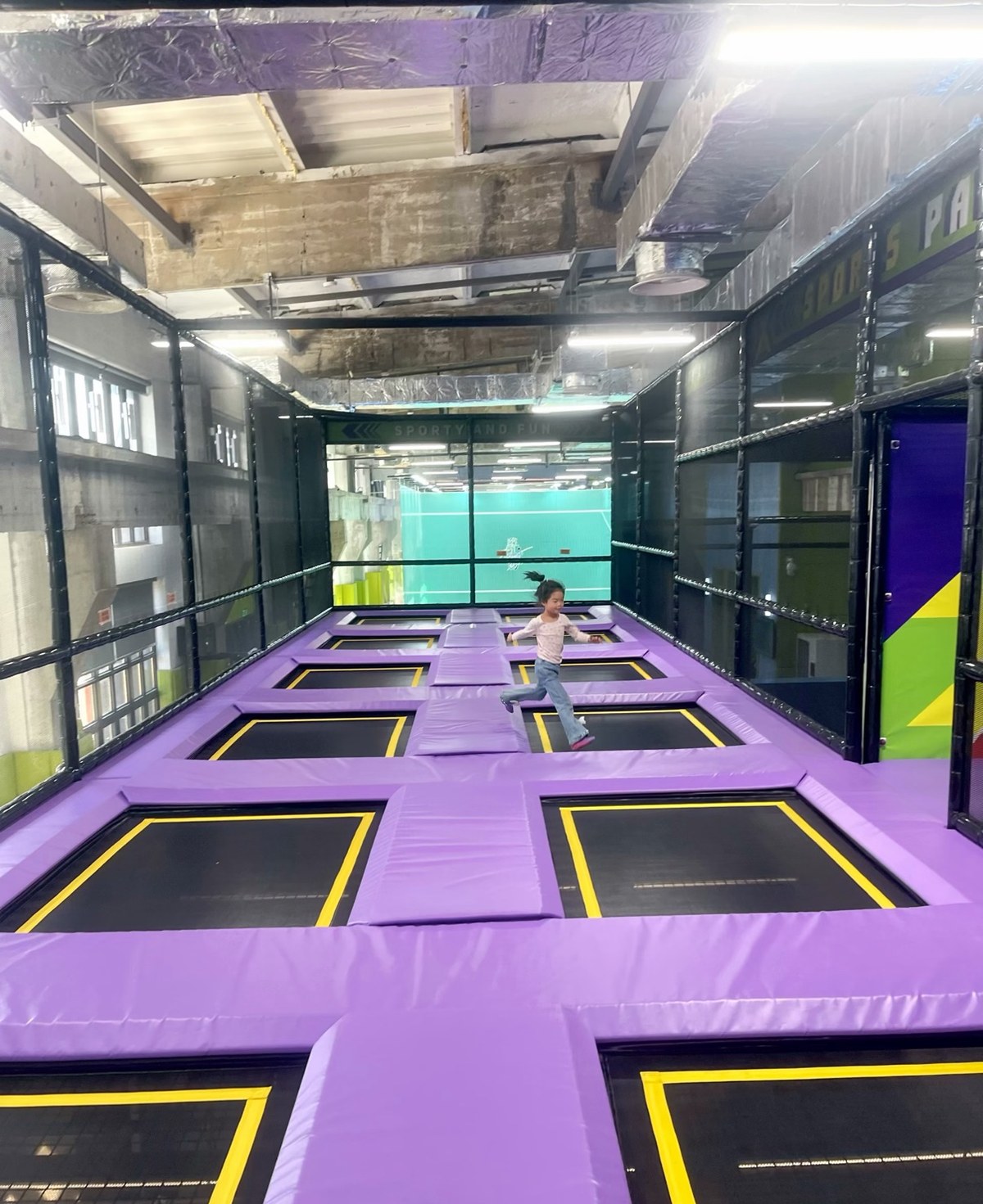 Wall-to-wall trampoline courts with purple padding