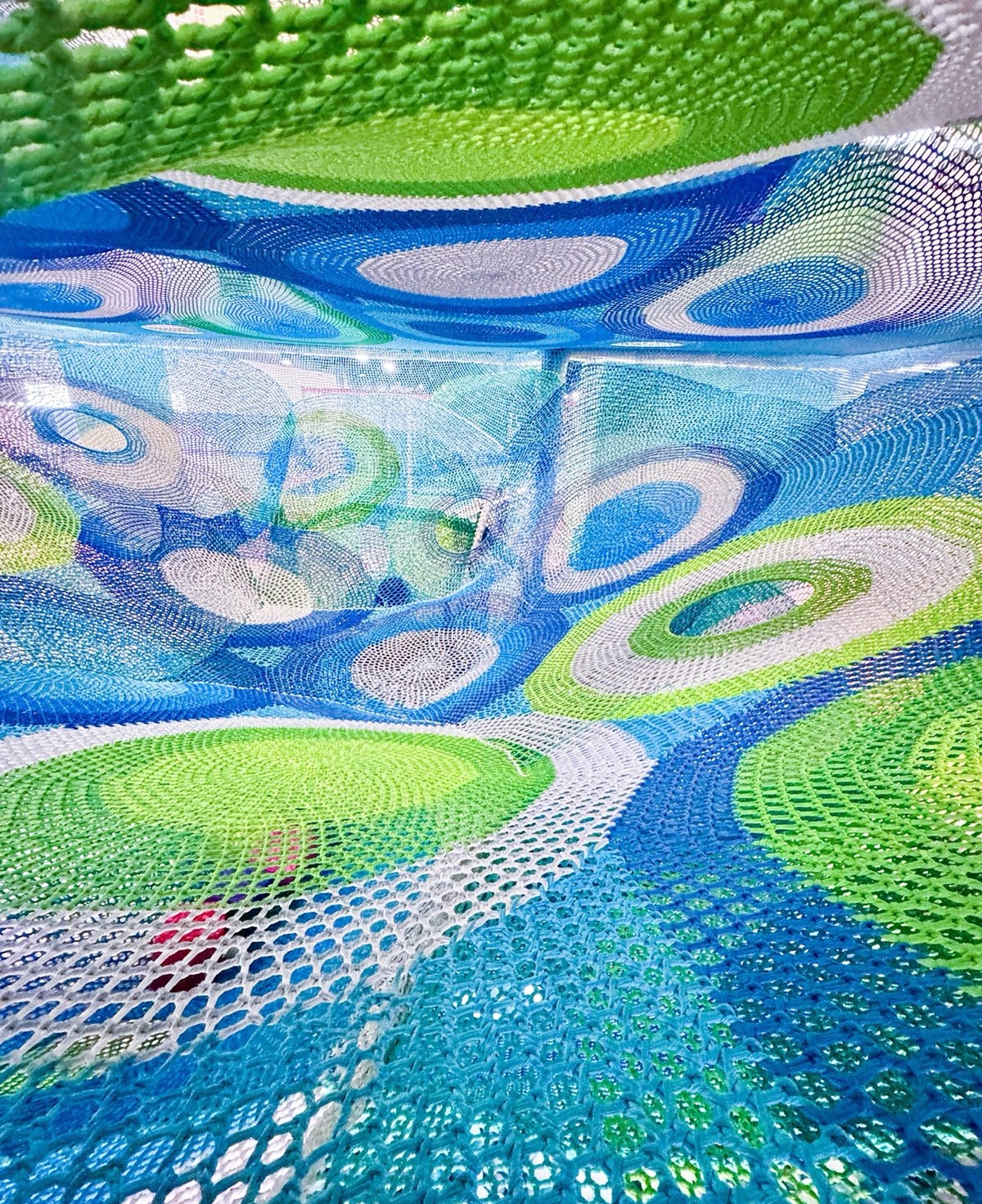Layered rainbow crochet nets seen from inside