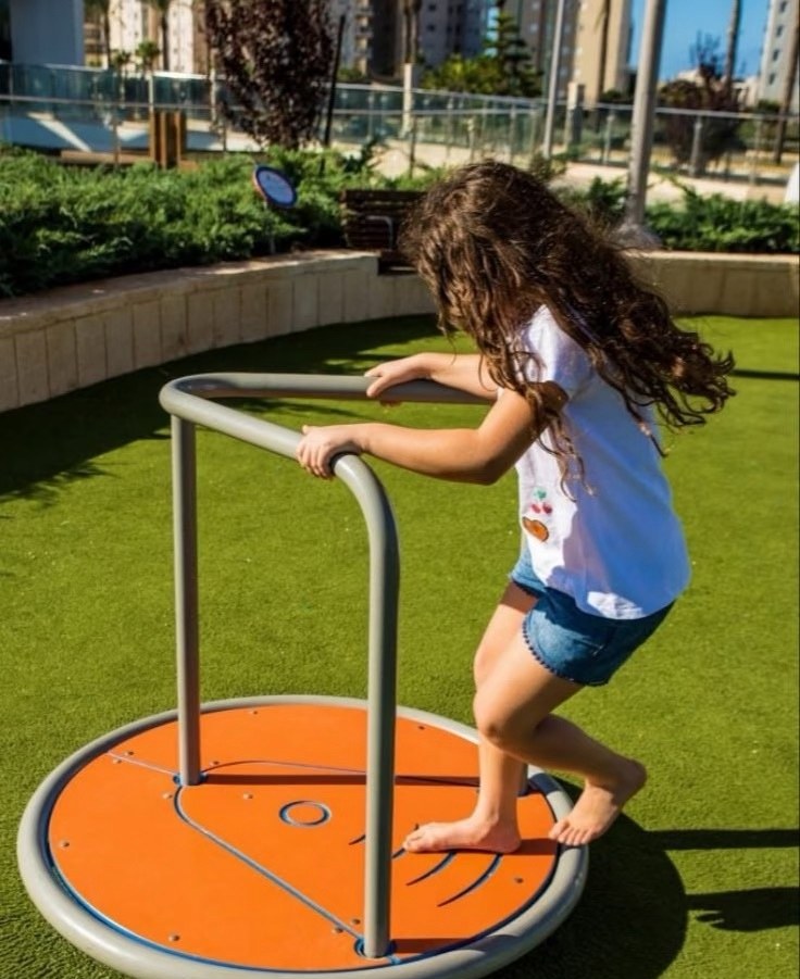 Girl balancing on a stand-on spinning disc