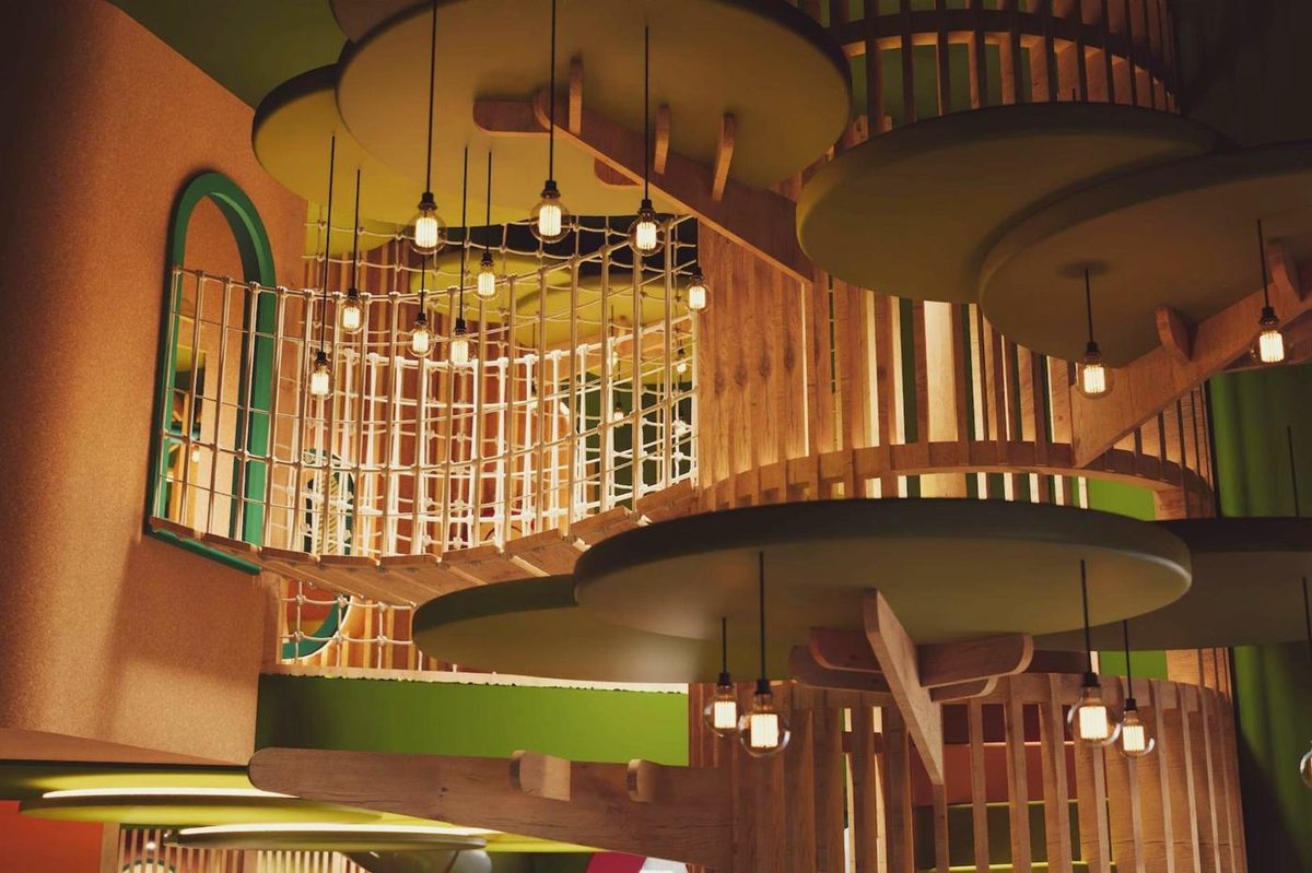 Wooden play structure with rope bridge and climbing nets