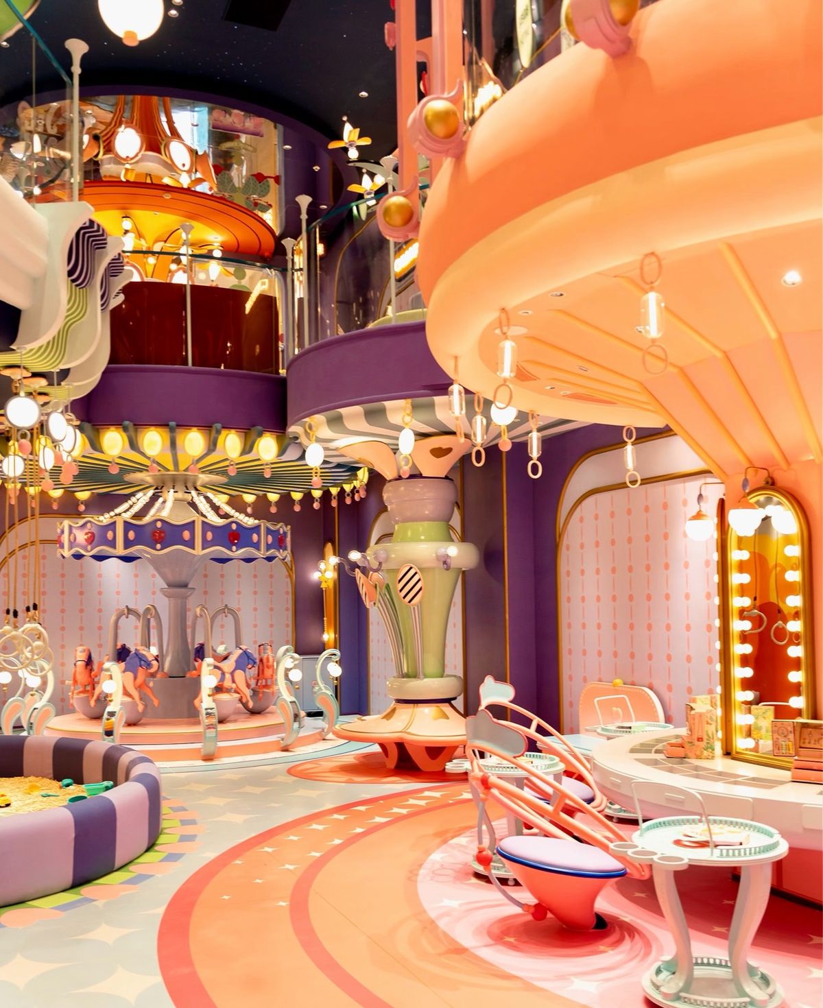 Fairytale indoor play palace with a carousel and candy colours