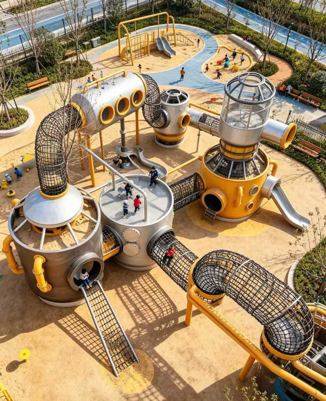 Aerial view of a stainless steel tank and net-tunnel outdoor playground