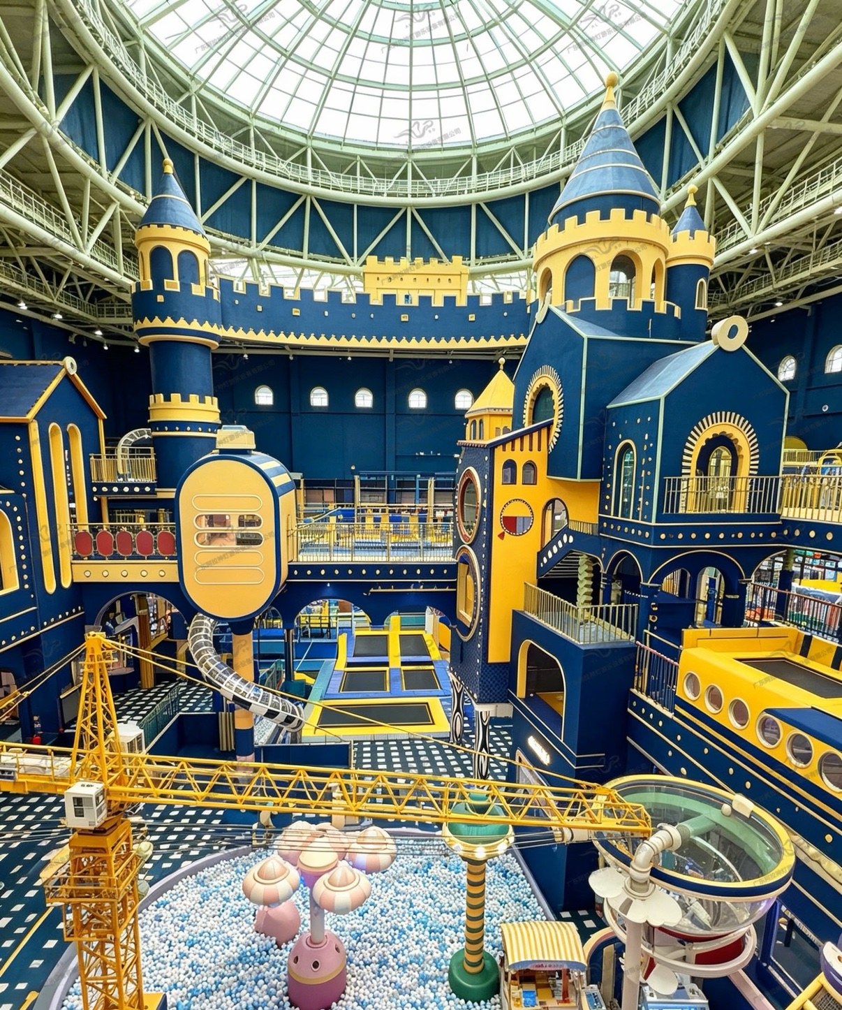 Huge blue and yellow castle themed indoor playground