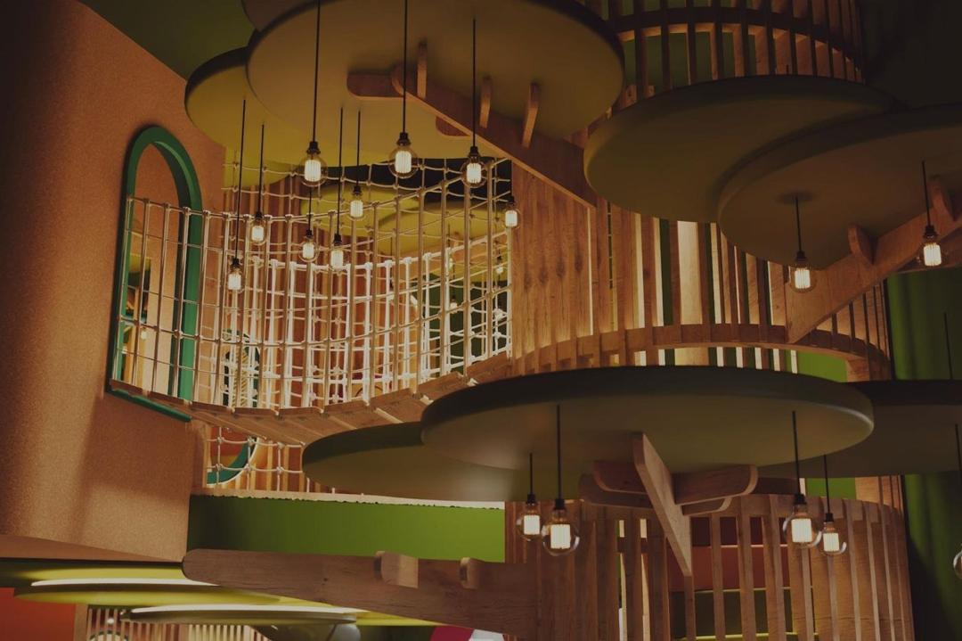 Habitat Collection natural timber indoor playground in soft green tones